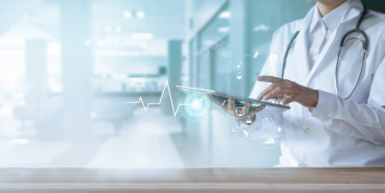 An image showing a female doctor using a tablet